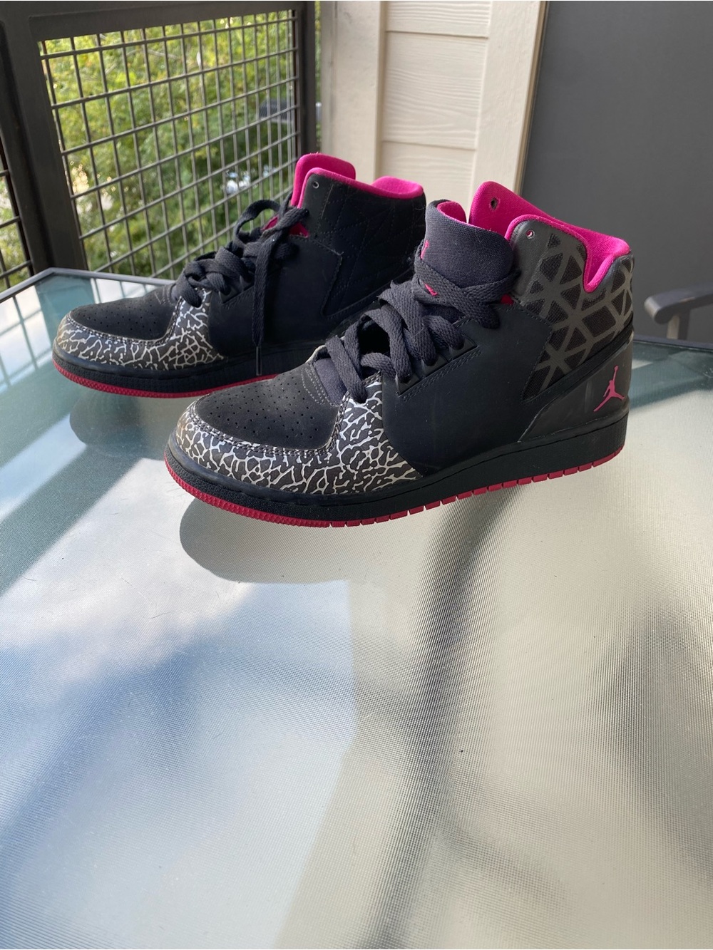Kids Jordan’s Black and Pink Mid-Top Sneakers